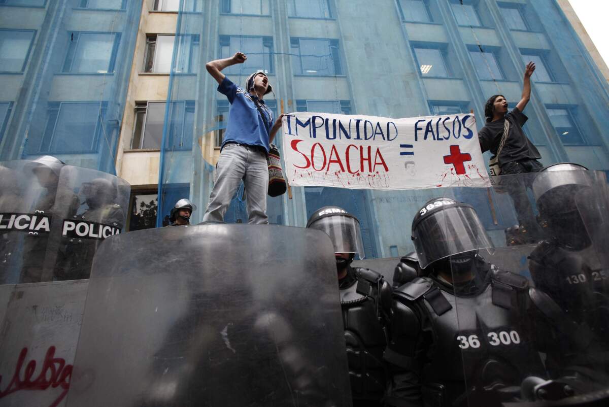 ARCHIVO - Estudiantes sostienen un cartel durante una protesta en Bogotá, Colombia