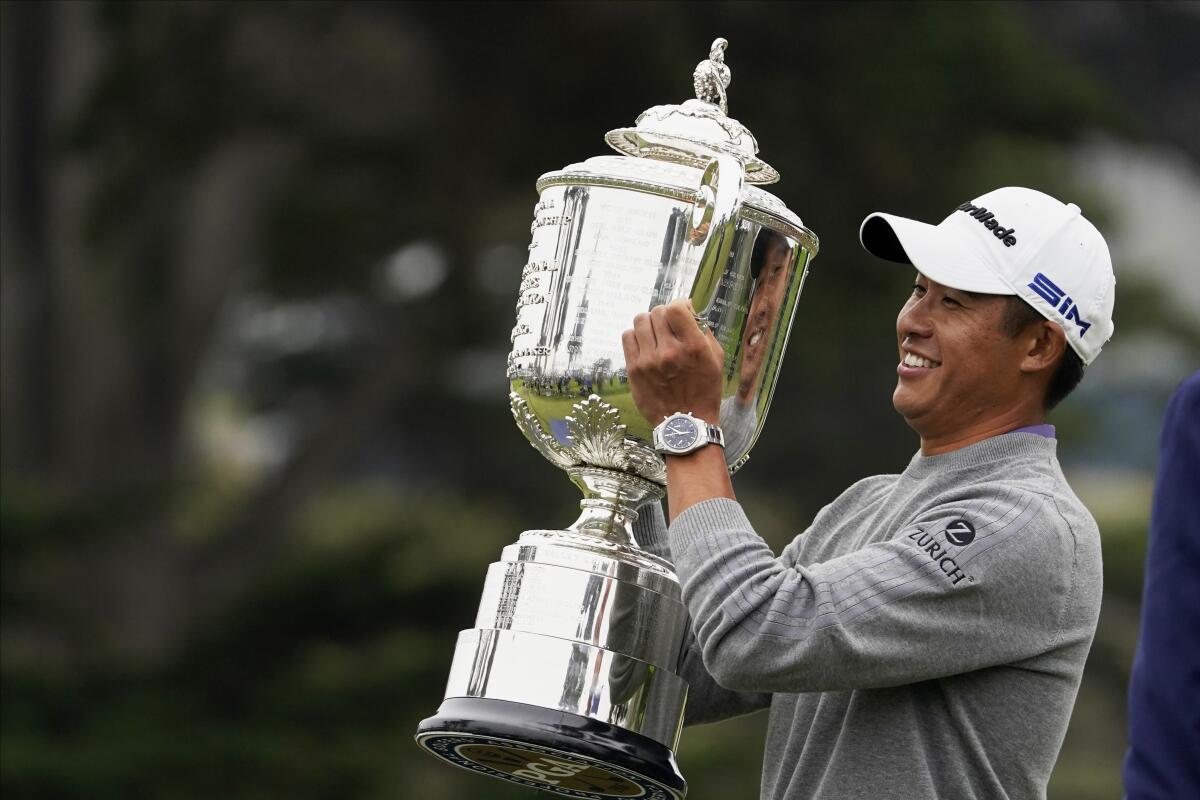 Collin Morikawa holds the Wanamaker Trophy after winning the PGA Championship.