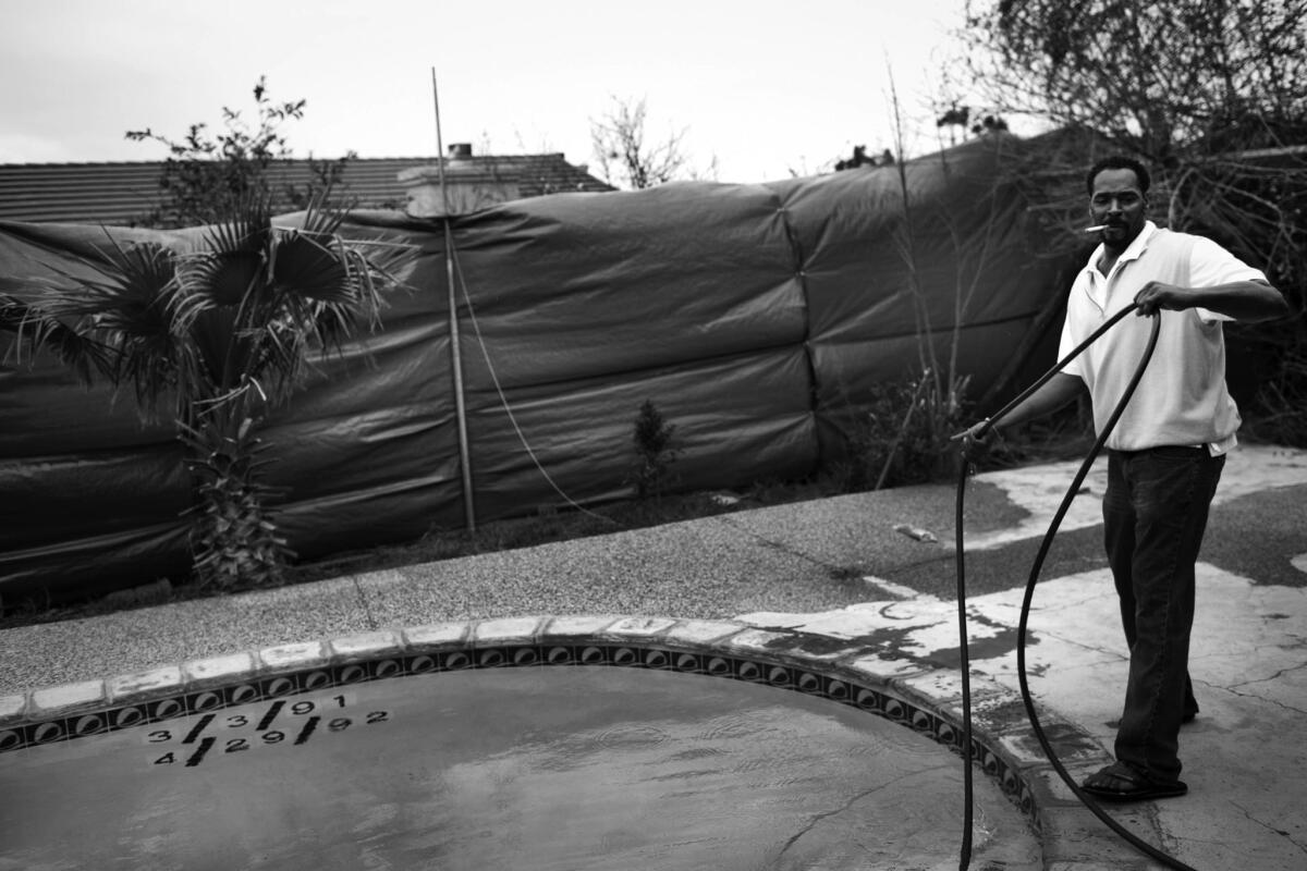 March 26, 2012: King covered his fences to keep neighbors from peering into his yard. The dates in the pool refer to the day he was beaten and the day the riots began.