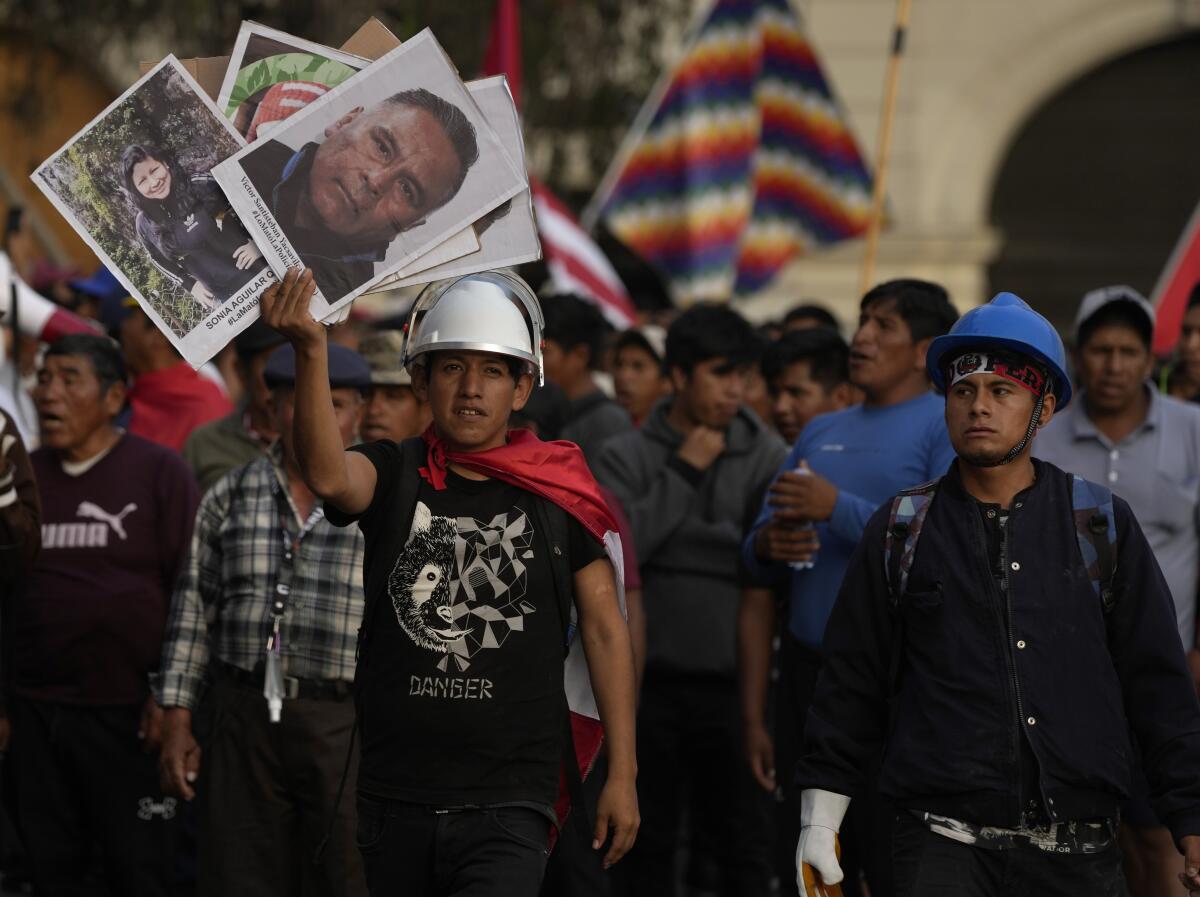 Bearing  photos of the victims of political violence, demonstrators march against Peruvian President Dina Boluarte