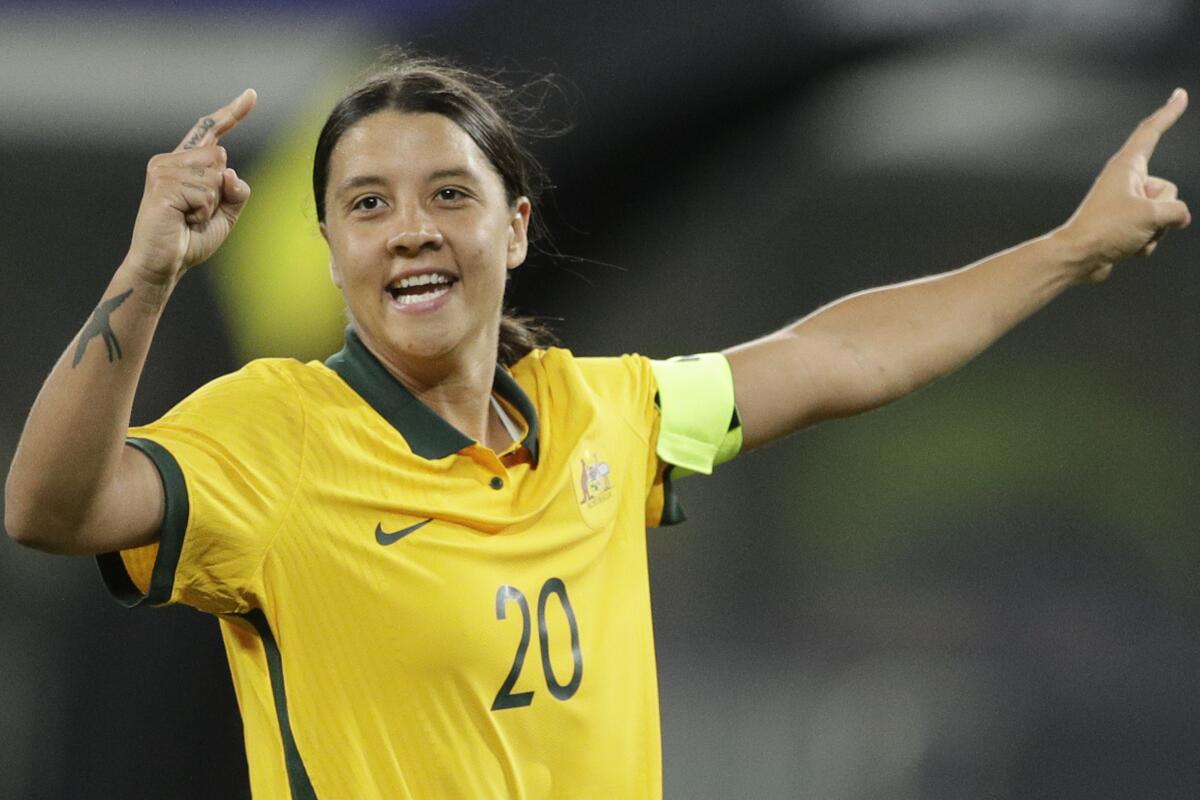 FILE - Australia's Sam Kerr gestures after scoring a goal against Brazil during their friendly soccer match in Sydney, Australia on Tuesday, Oct. 26, 2021. Kerr and Manchester City defender Alanna Kennedy have been recalled to Australia’s squad for two matches against Olympic champion Canada in September that will kick off the Matildas’ final phase of preparations for a World Cup on home soil in 2023. (AP Photo/Rick Rycroft, File)