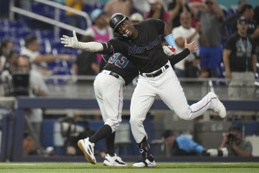 Miami Marlins' Jesus Sanchez celebrates with third base coach Jody Reed (33) while heading home on a three-run home run durin g the third inning of the team's baseball game against the Kansas City Royals, Wednesday, June 7, 2023, in Miami. (AP Photo/Peter Joneleit)