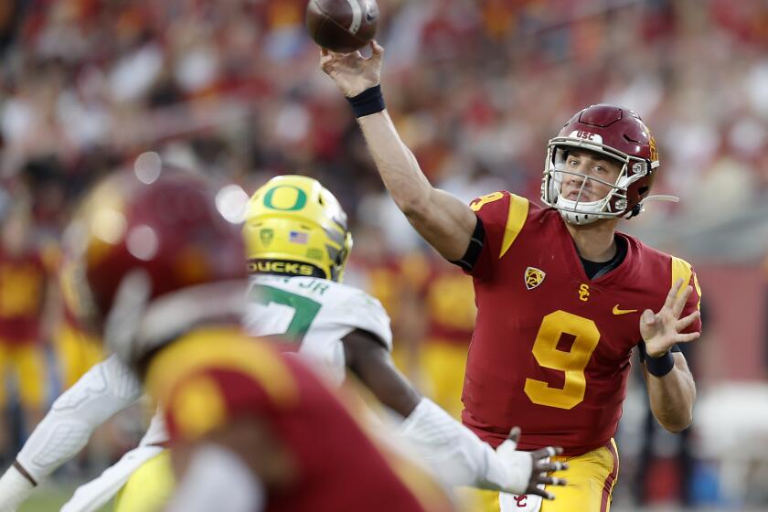 LOS ANGELES, CALIF. - OCT. 19, 2019. USC quarterback Kedon Slovis throws downfield against Oregon in the fourth quarter at the Coliseum on Saturday night, Niov,. 2, 2019. (Luis Sinco/Los Angeles Times)