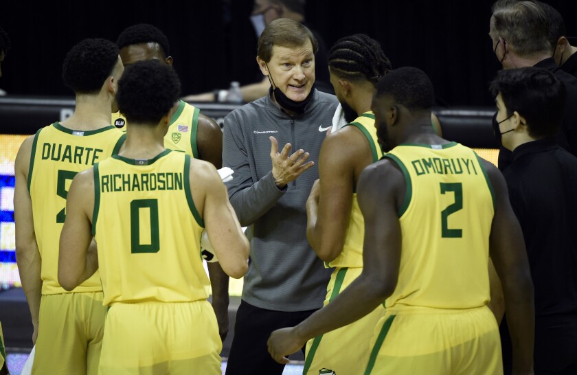 Oregon coach Dana Altman talks with his team.