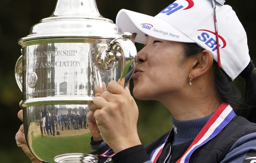 A Lim Kim, of South Korea, kisses the championship trophy after winning the U.S. Women's Open golf tournament, Monday, Dec. 14, 2020, in Houston. (AP Photo/Eric Gay)