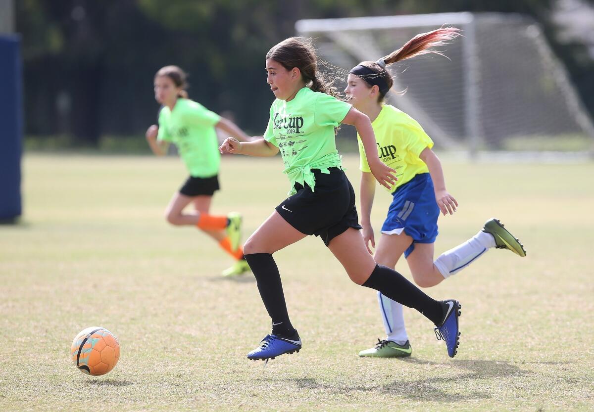 Pegasus School's Talia Ghorban dribbles the ball against Newport Coast in a girls’ fifth- and sixth-grade Silver Division pool-play match at the Daily Pilot Cup on Friday at Jack R. Hammett Sports Complex in Costa Mesa.