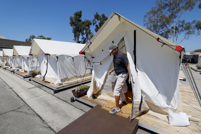 Culver City, CA, Friday, August 25, 2023 - JerryWashington exits his tent at an Urban Alchemy Safe Sleep Village. (Robert Gauthier/Los Angeles Times)