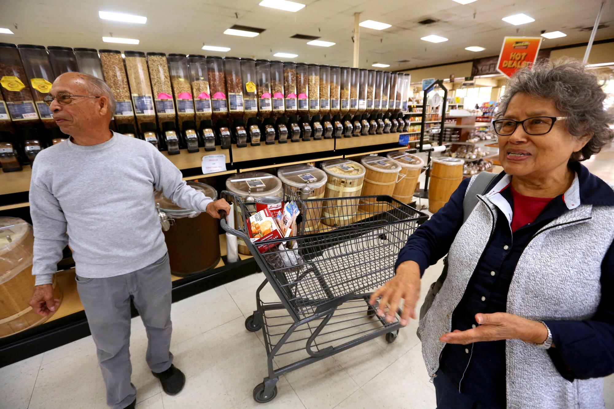 Danny Perez, left, and his wife, Martha, shop at the Loma Linda Market in Loma Linda.