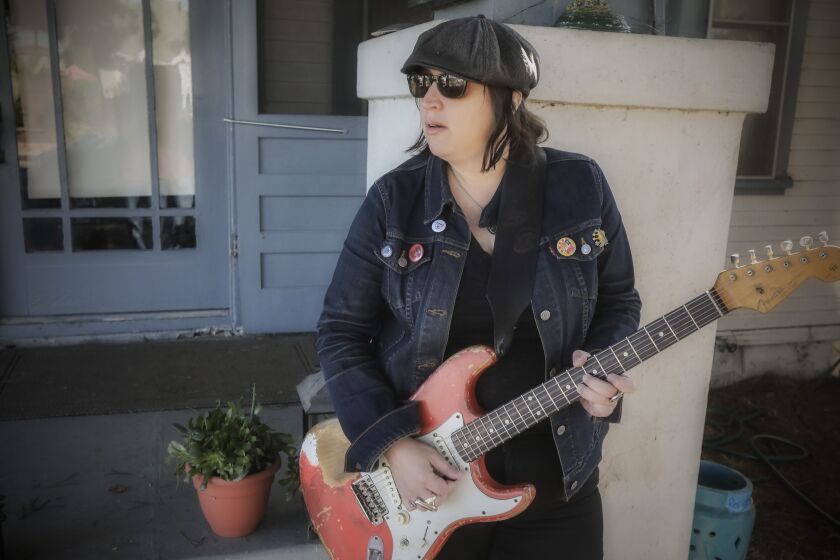 SAN DIEGO, CA - OCTOBER 27: Guitarist Laura Chavez plays on the porch where she performs in Normal Heights on Tuesday, Oct. 27, 2020 in San Diego, CA. (Eduardo Contreras / The San Diego Union-Tribune)