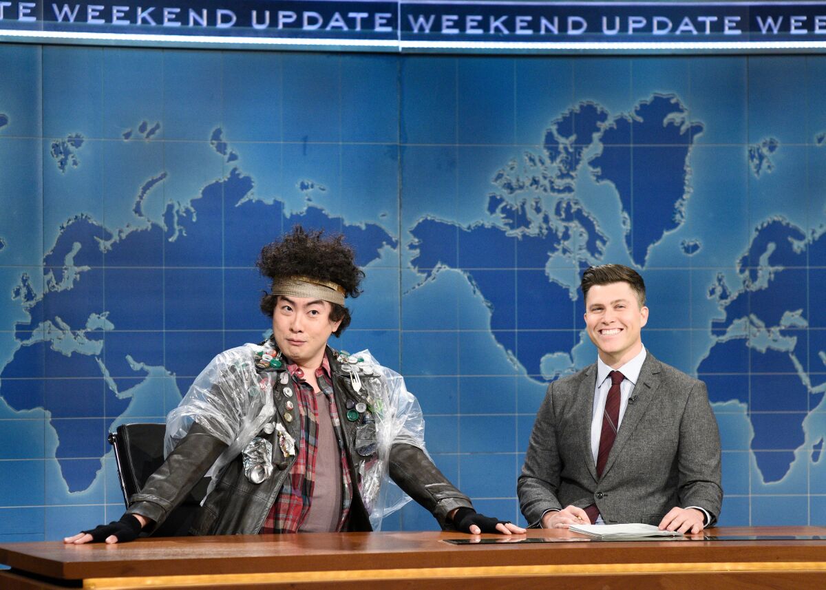  Bowen Yang as Bottle Boy and anchor Colin Jost during Weekend Update 