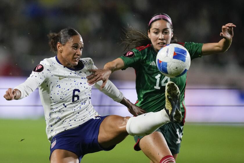 United States forward Lynn Williams, left, and Mexico defender Greta Espinoza, right, vie for the ball.