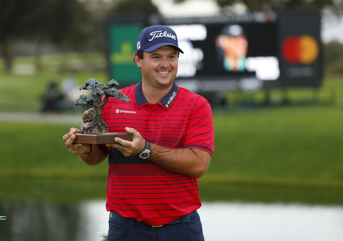 Patrick Reed, shown during a socially-distanced trophy ceremony, shot 14-under to win the Farmers Insurance Open.