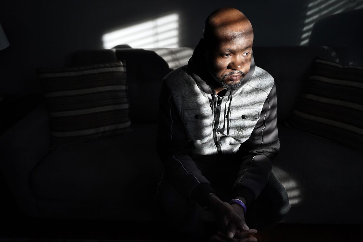 Orville Howden, 39, of Jamaica, speaks with a reporter from The Associated Press, Wednesday, Dec. 1, 2021, at a home recently renovated by the LGBT Asylum Task Force, in Worcester, Mass. Howden, a gay man who moved into the house in November of 2021, said he fled Jamaica in October of 2020 after his roommate in Montego Bay was killed for being gay. The Caribbean nation is among roughly 70 countries, mostly in Africa, where homosexuality is explicitly outlawed, according to the International Lesbian, Gay, Bisexual, Trans and Intersex Association, a Swiss group that tracks the laws. (AP Photo/Steven Senne)