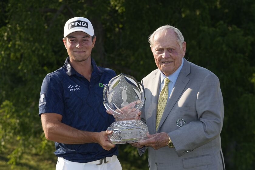 Viktor Hovland, left, of Norway, and Jack Nicklaus hold the trophy after Hovland won the Memorial golf tournament, Sunday, June 4, 2023, in Dublin, Ohio. (AP Photo/Darron Cummings)