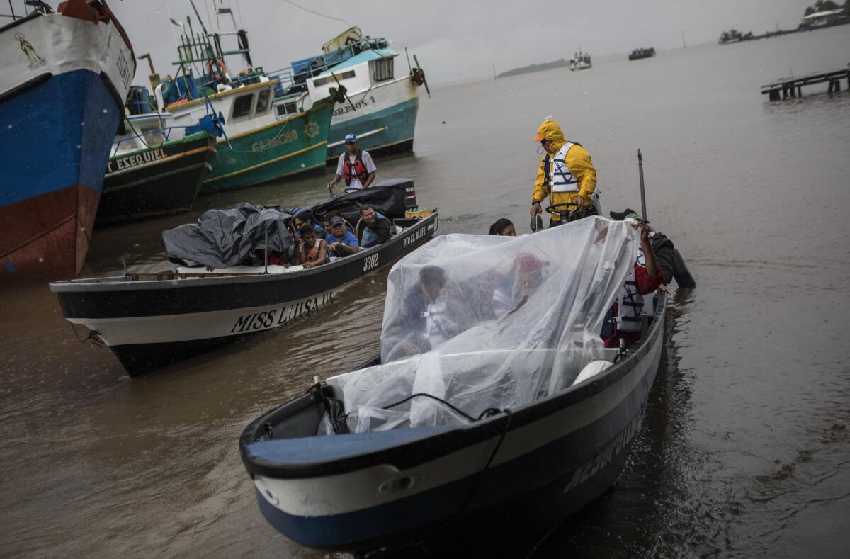 People leave the port by boat to return their communities amid the arrival of Tropical Storm Bonnie in Bluefields, Nicaragua, July 1, 2022. Tropical Storm Bonnie has formed over the Caribbean as it heads for a quick march across Central America and potential development into a hurricane after reemerging in the Pacific. (AP Photo/Inti Ocon)