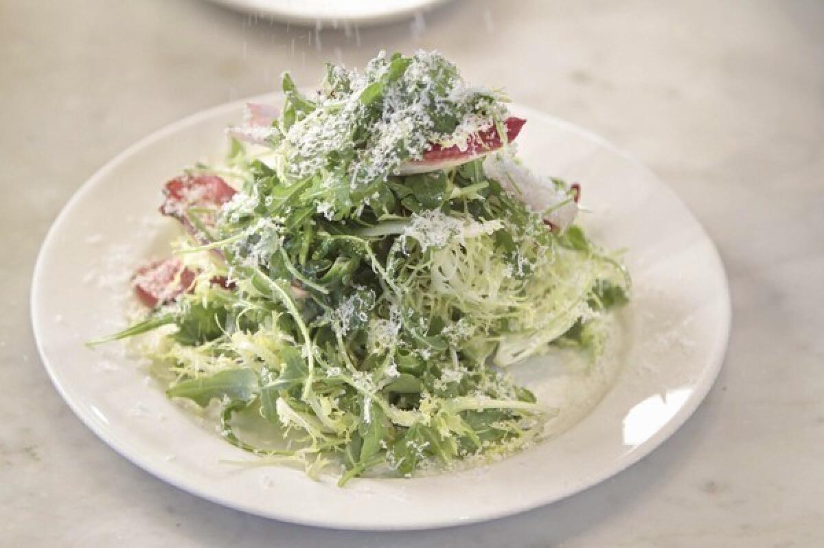 Salad with Parmigiano-Reggiano and anchovy dressing.