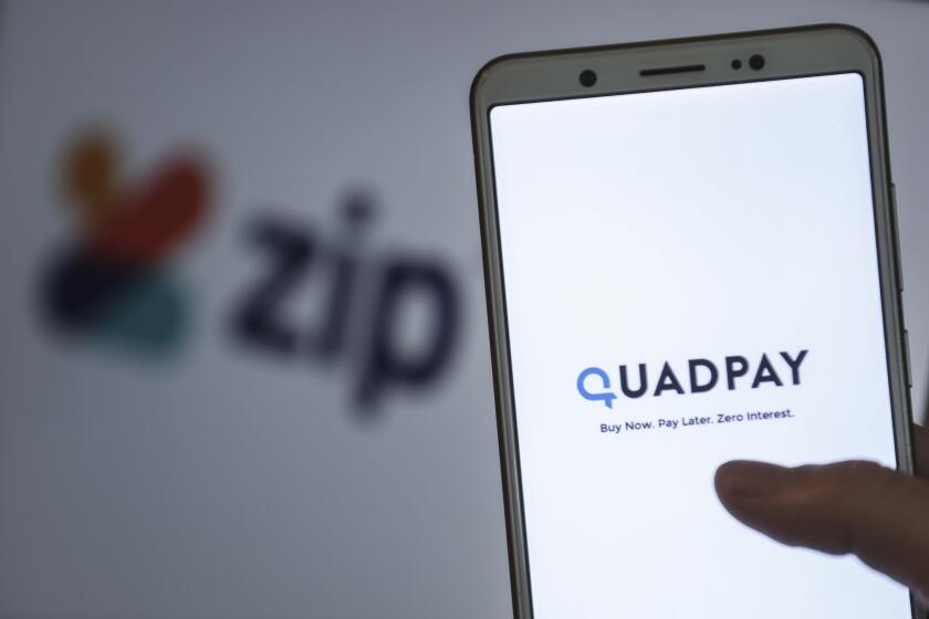 QuadPay, a buy now pay later mobile shopping app is displayed on a smartphone.