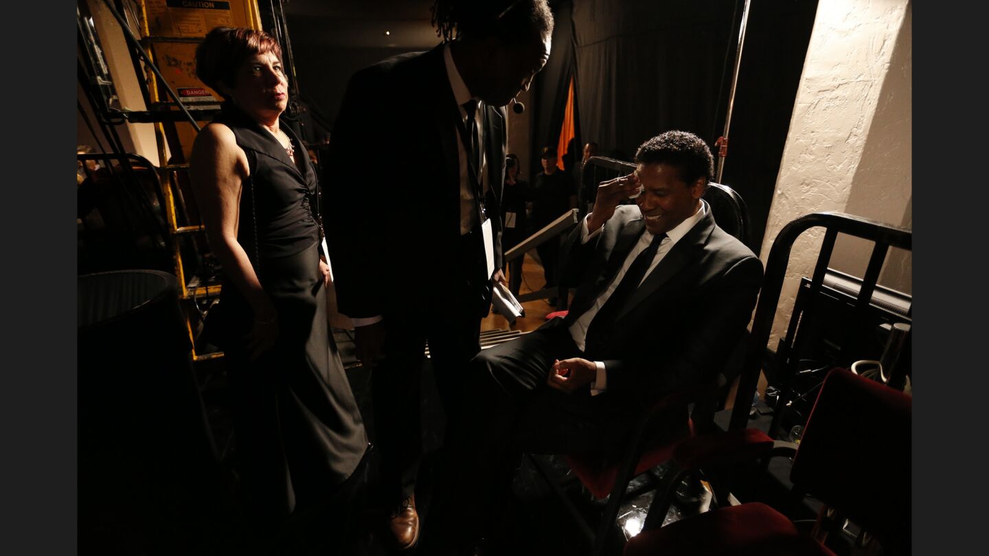 Denzel Washington is congratulated backstage by stage manager Valdez Flagg and Rosalind Jarrett Sepulveda eft) after winning Outstanding Performance by an Actor in a Leading Role for "Fences."