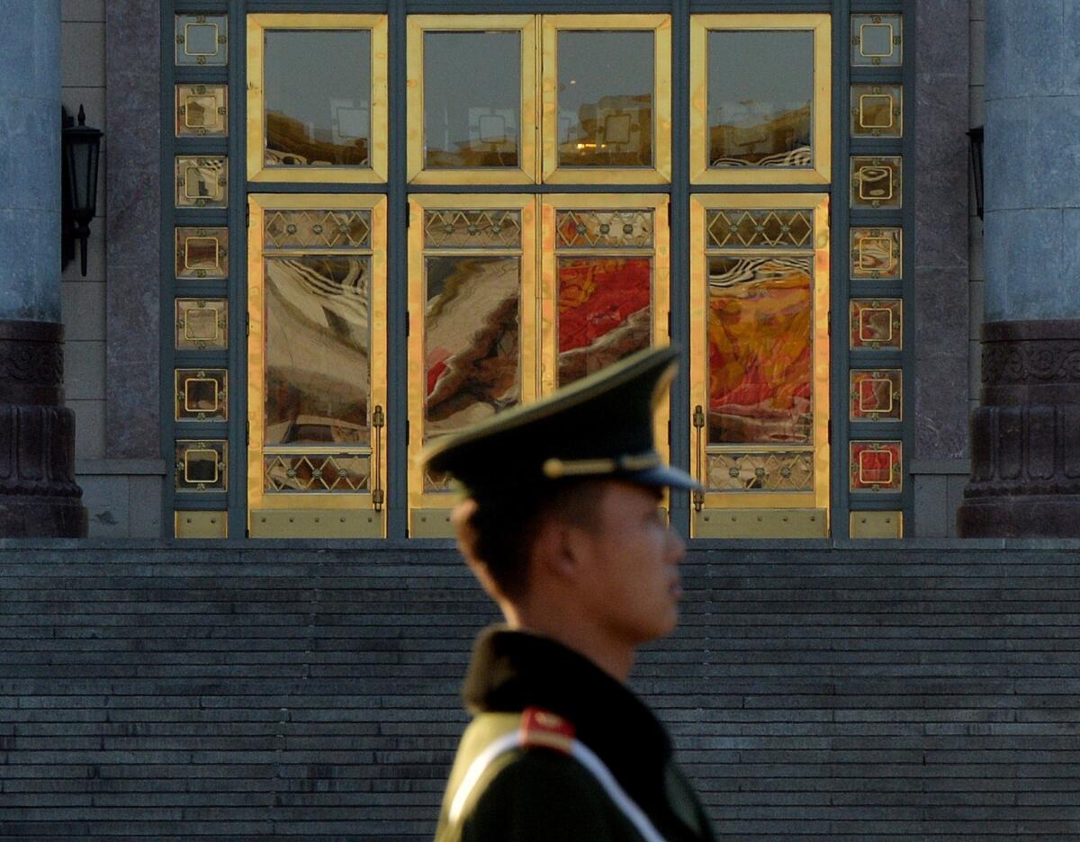 A Chinese paramilitary police officer stands guard beside the Great Hall of the People after the Communist Party Central Committee concluded its secretive Third Plenum in Beijing.