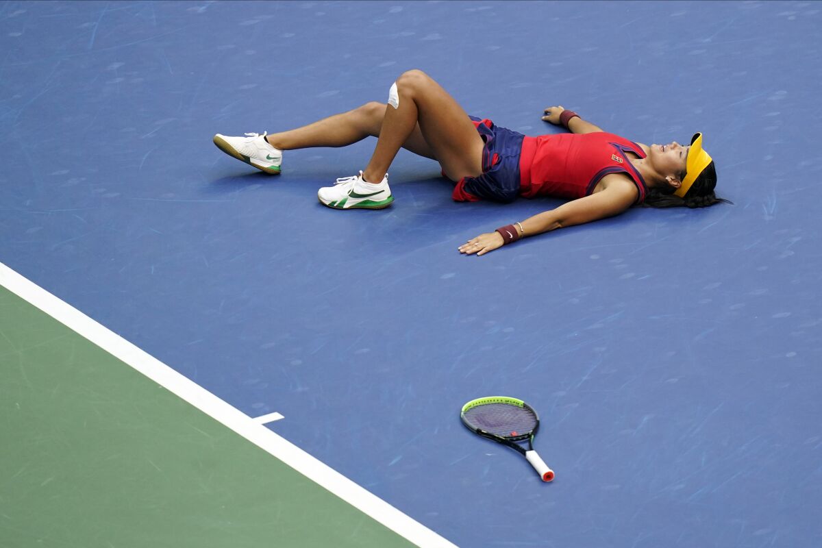 Emma Raducanu falls to the court after defeating Leylah Fernandez for the U.S. Open women's singles title Saturday.
