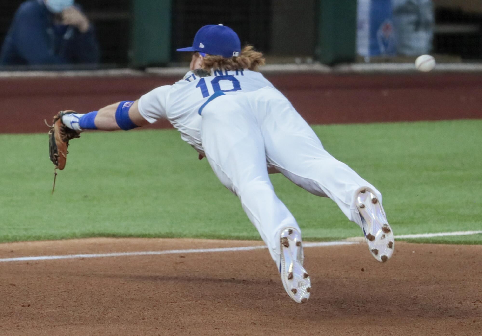Dodgers third baseman Justin Turner can't corral a run-scoring double by Atlanta's Cristian Pache.