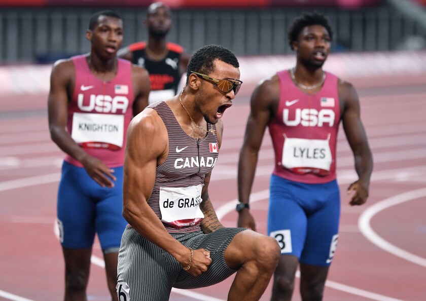 Canada's Andre de Grasse celebrates winning the gold medal in the 200m final.
