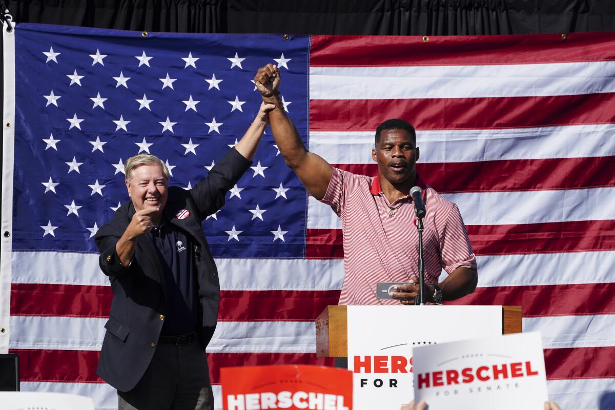 GOP Senate candidate Herschel Walker campaigns with Sen. Lindsey Graham in Cumming, Ga., on Oct. 27.