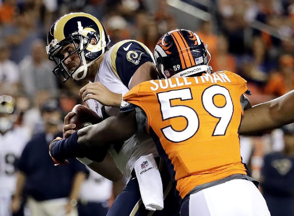 Rams quarterback Sean Mannion is sacked by Broncos linebacker Sadat Sulleyman.