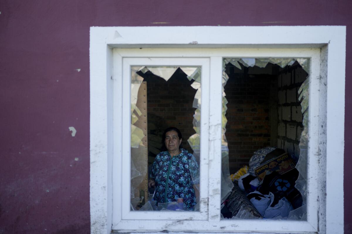Woman looking out of shattered window