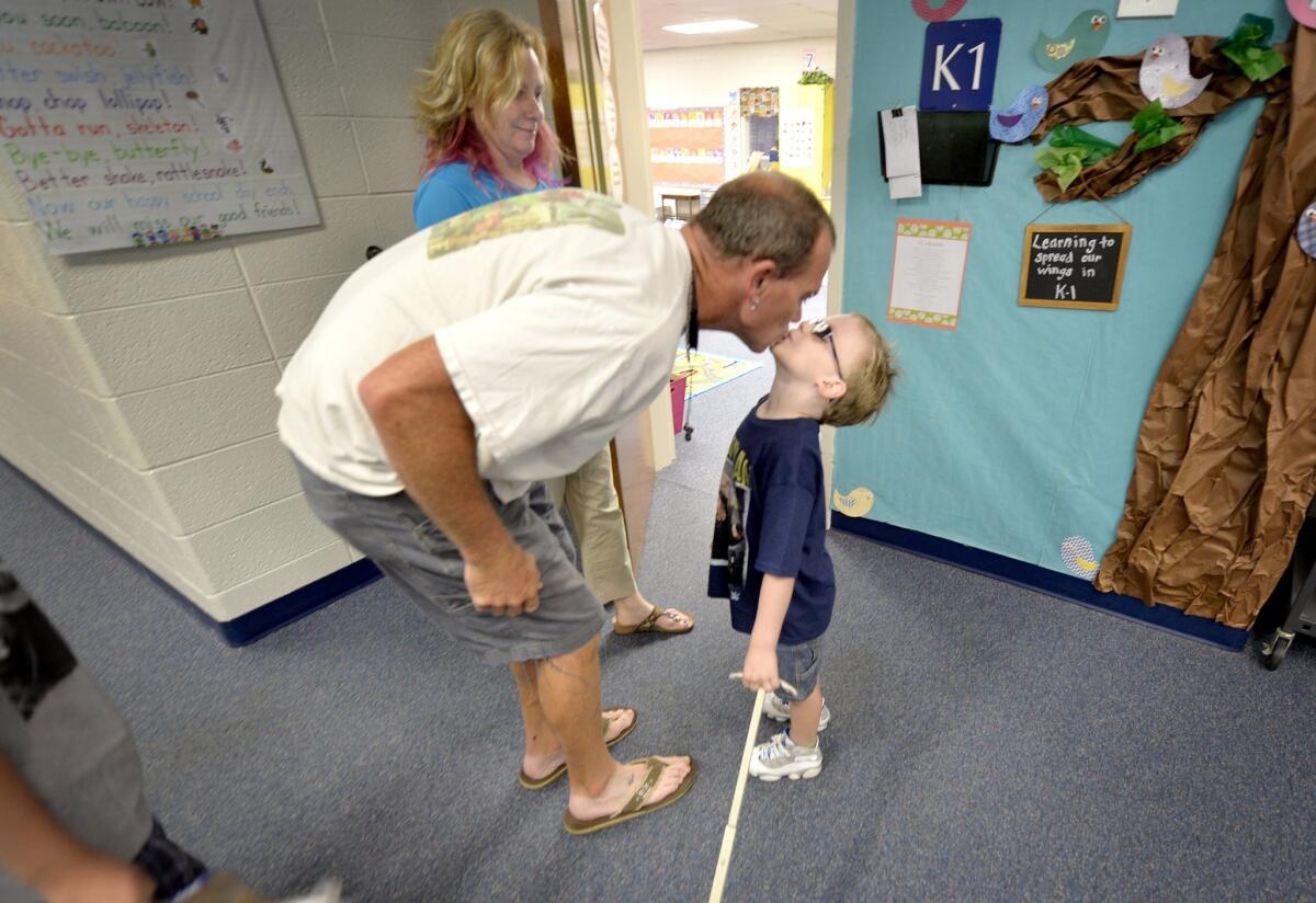 Students benefit from parents and teachers communicating well, a new study shows. Shane Warren kisses son Miles, 5, as he drops him off for his first day of school in North Augusta, S.C., as mom DeAnne looks on.