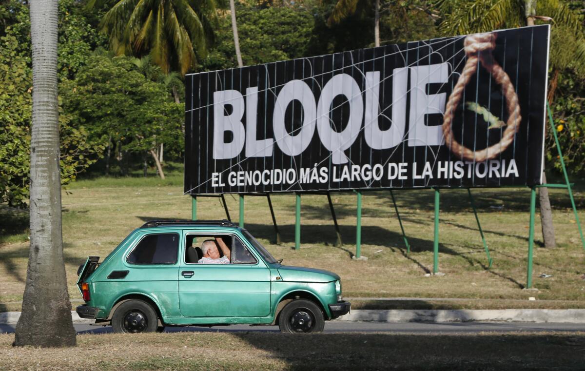 People drive in Havana on Friday past a billboard that reads in Spanish, "Blockade, the longest genocide in history," a reference to the U.S. trade embargo imposed on Cuba.