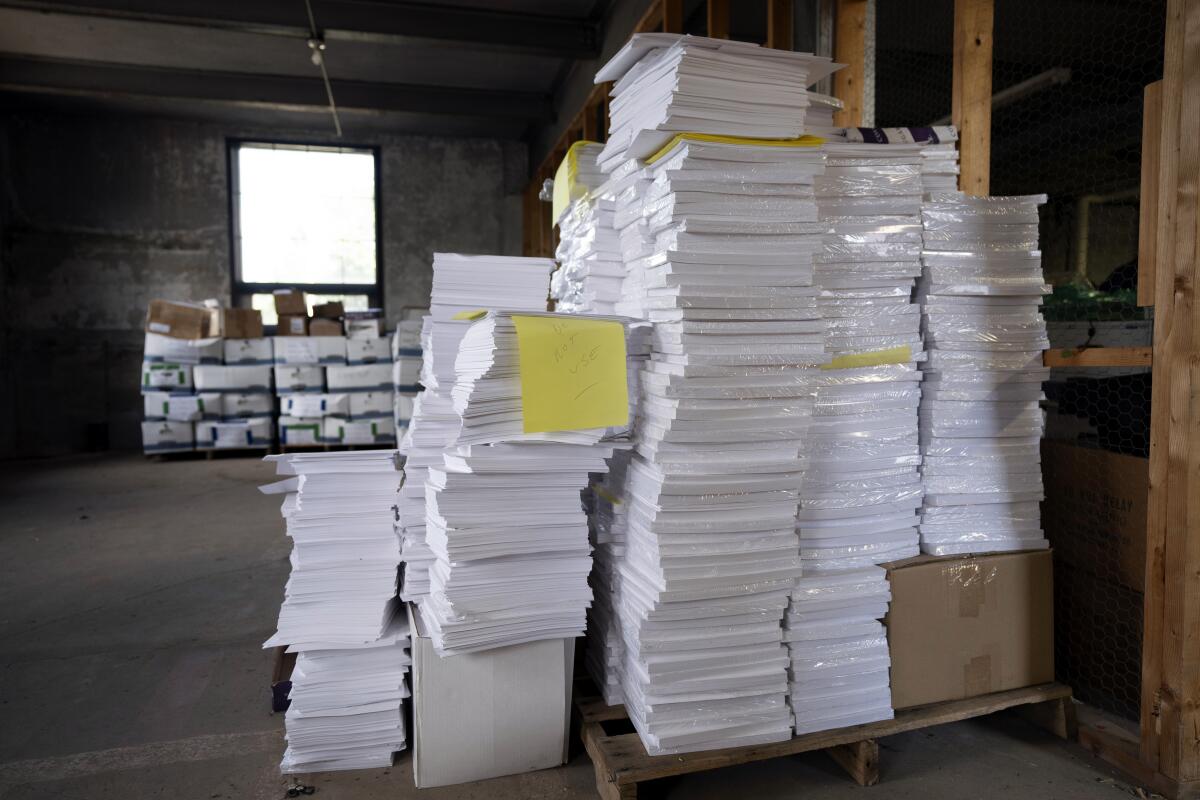 Stacks of paper too thick for Luzerne County's election equipment in a warehouse.