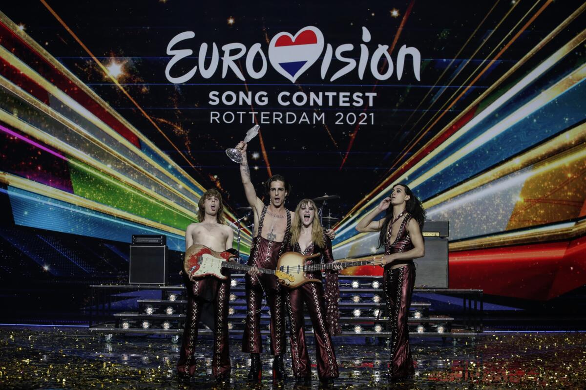 The band Maneskin holds up a trophy on the Eurovision Song Contest stage