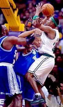 Devean George, center, and Horace Grant team up to stop the Boston Celtic's Paul Pierce from scoring.