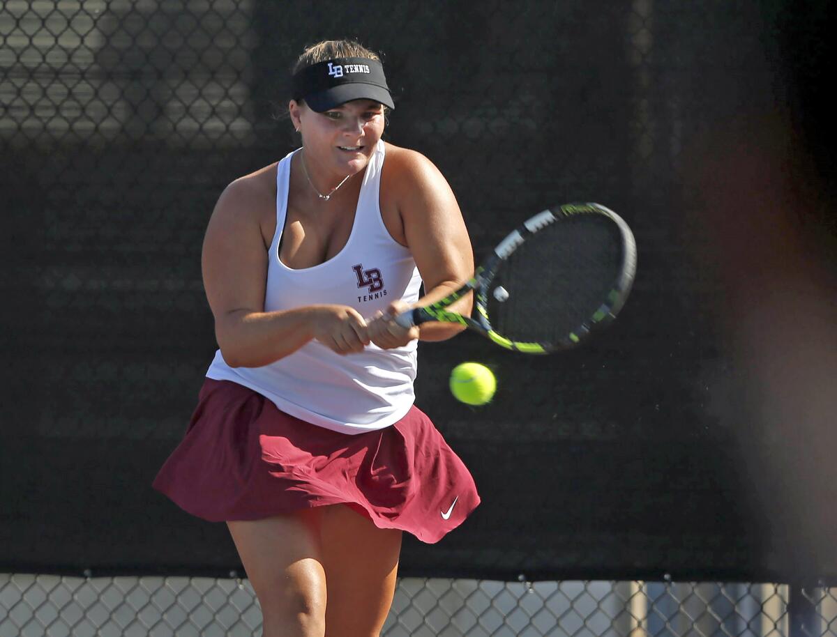 Laguna Beach's Jessica MacCallum hits a backhand in a match against Corona del Mar earlier this season.