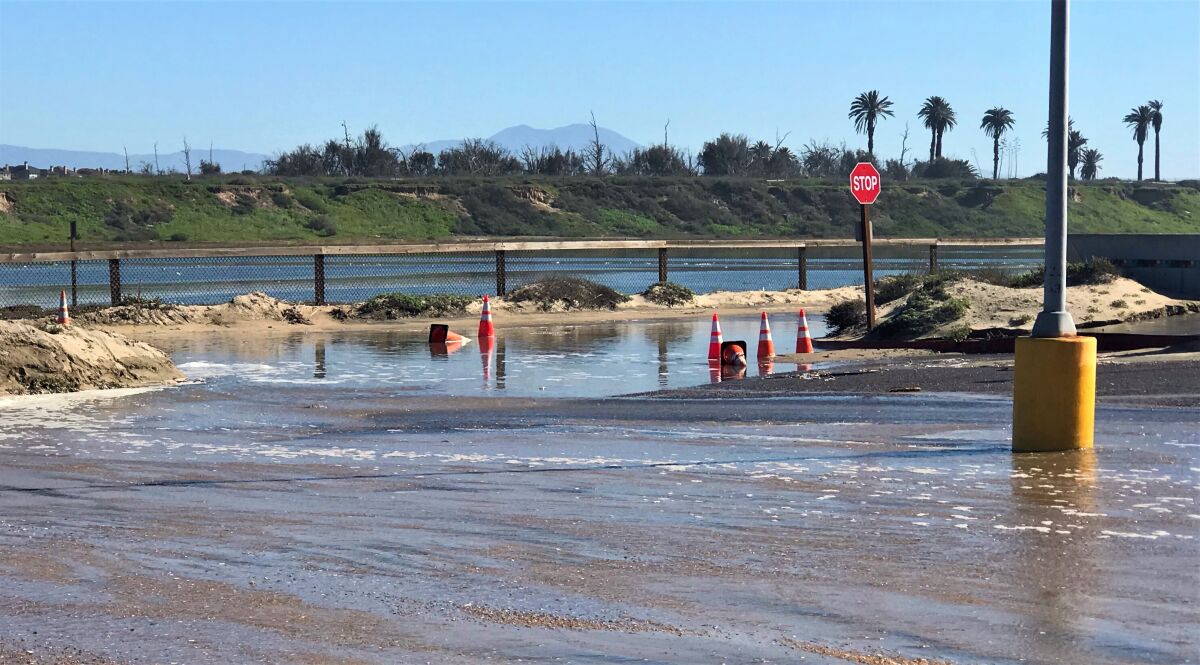 A parking lot near Pacific Coast Highway in Huntington Beach was hit by a tidal surge Tuesday that closed the highway. 