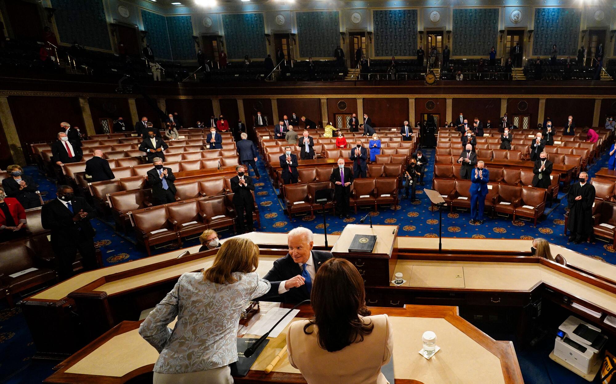 President Joe Biden bump elbows with Speaker of the House Nancy Pelosi after his address.