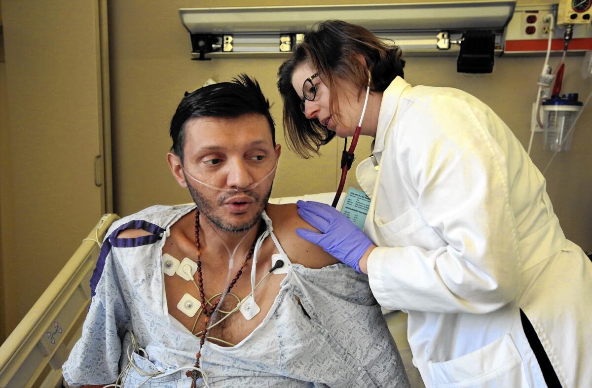 Dr. Caitlin Reed examines her patient at Olive View-UCLA Medical Center in Sylmar. He suffers from extensively drug-resistant tuberculosis.