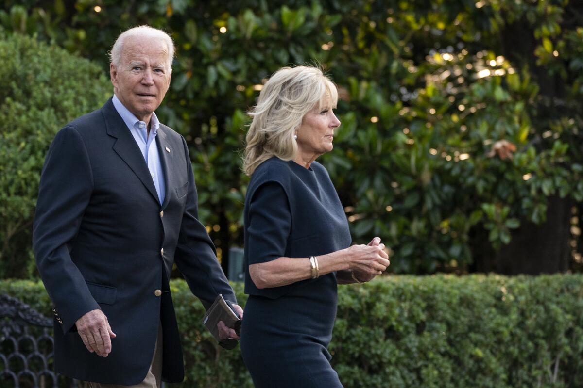 President Joe Biden and first lady Jill Biden walk on the South Lawn at the White House in Washington, Thursday, July 1, 2021, to board Marine One on their way for a brief stop to switch on Air Force One at nearby Andrews Air Force Base, Md., that will take them to Florida. (AP Photo/Manuel Balce Ceneta)