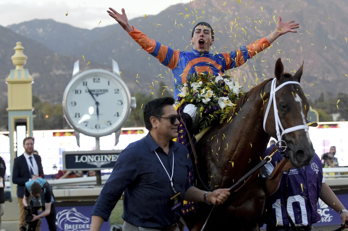 Jockey Irad Ortiz, Jr. celebrates on the way to the Winner's Circle after guiding Vino Rosso to victory in the Breeders' Cup Classic on Nov. 2, 2019, at Santa Anita Park.
