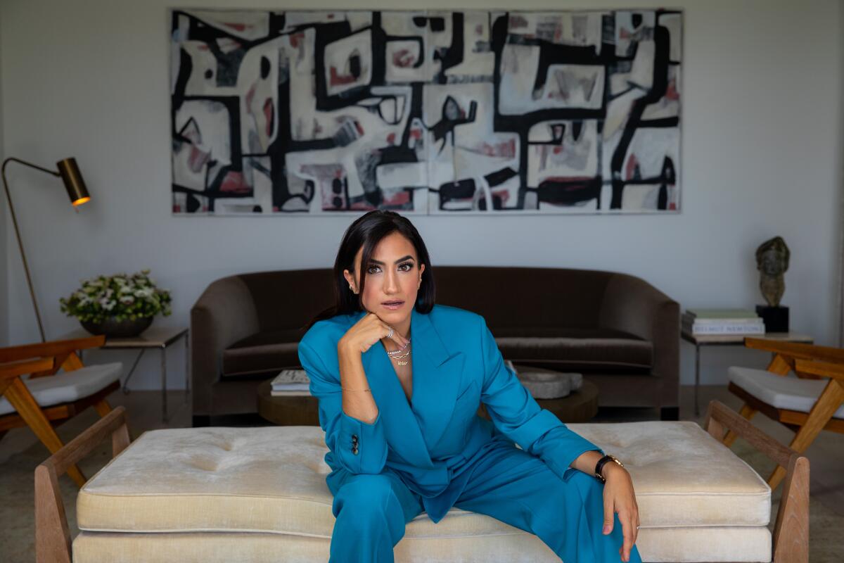 Mandana Dayani, creator and cofounder of I Am a Voter, in her home with an abstract work of art behind her.