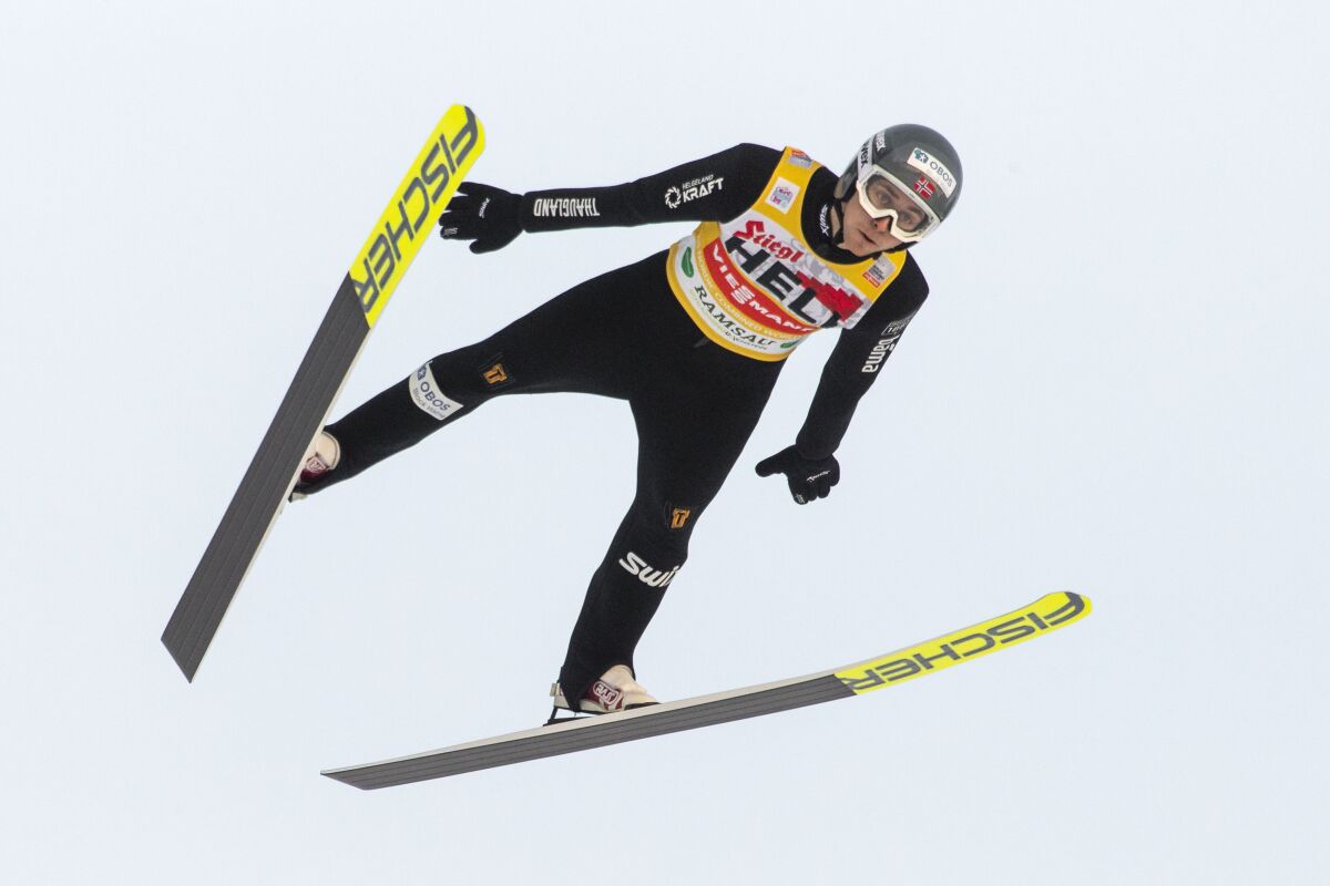 FILE - Jarl Magnus Riiber of Norway soars through the air during the men's ski jumping competition at the Nordic Combined World Cup in Ramsau, Austria, Sunday, Dec. 19, 2021. Norway’s Jarl Magnus Riiber has been so dominant in World Cup competitions that other Nordic combined athletes are trying to study how he soars past the competition in ski jumping so much so that he has a huge lead in cross-country skiing. (AP Photo/Lisa Leutner, File)