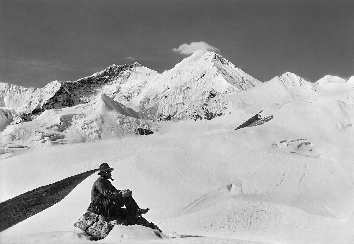 Team member with Mt. Everest, Kangshung Face and Lhotse from Karta Glacier, 1921.
