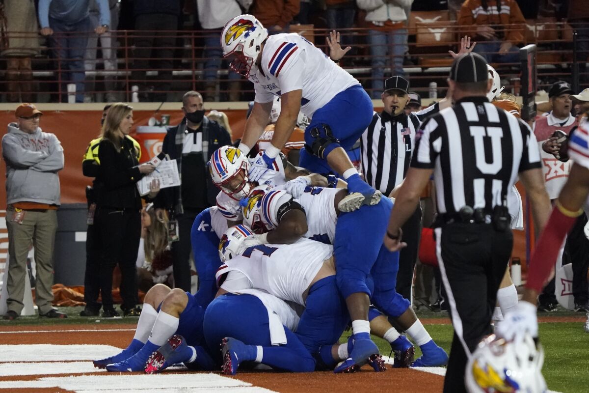 Kansas players celebrate their 57-56 win over Texas in overtime on Nov. 13, 2021. 