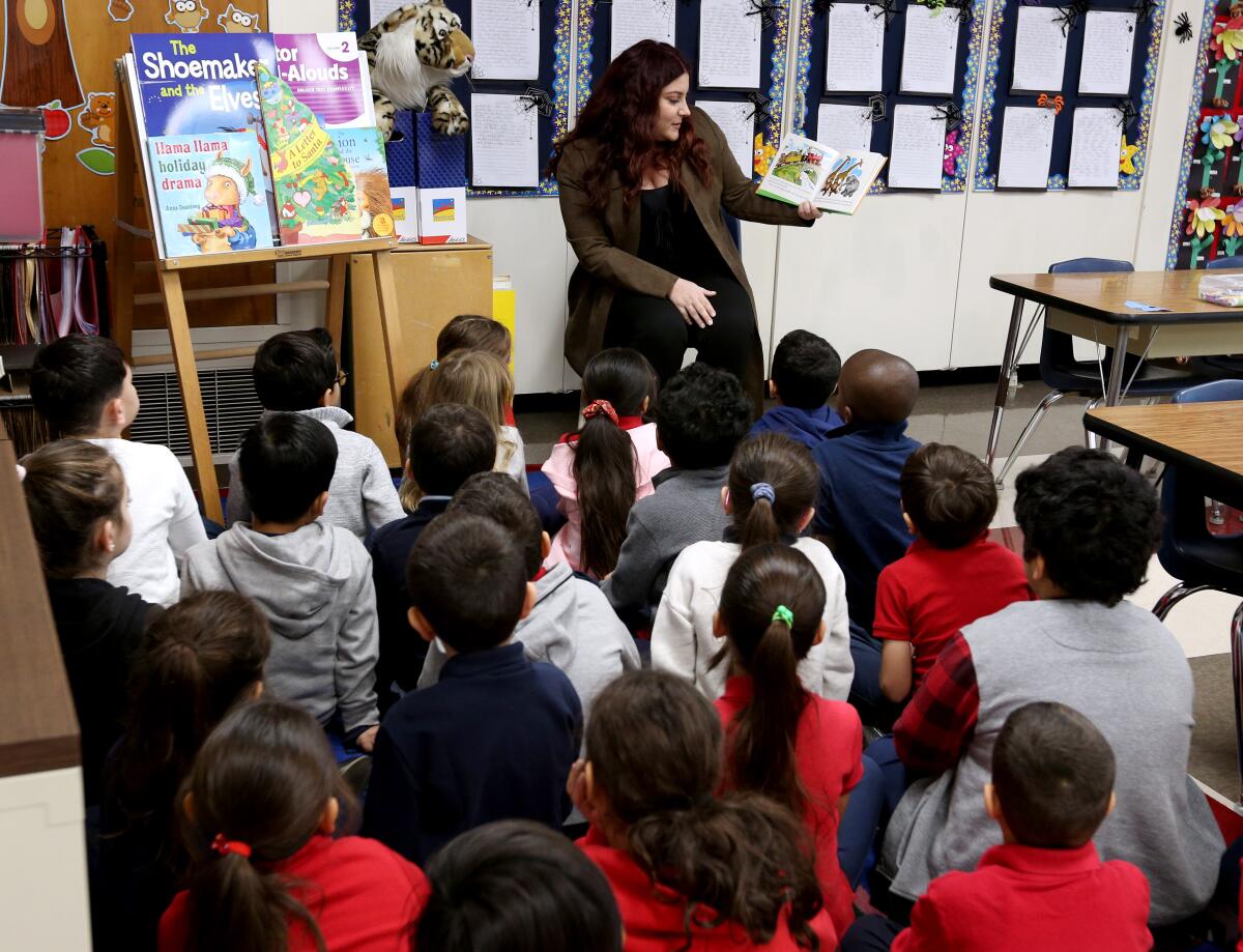 Mineh Petrosian, the new executive director of the Glendale Educational Foundation, reads to first-graders at Horace Mann Elementary School during the 28th annual Glendale Educational Foundation's Principal for a Day event in Glendale Unified on Tuesday.
