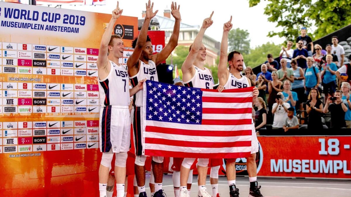 The USA three-on-three basketball team celebrates its victory on the podium after defeating Latvia during the FIBA 3x3 World Cup basketball at the Museumplein in Amsterdam, the Netherlands, on Sunday.