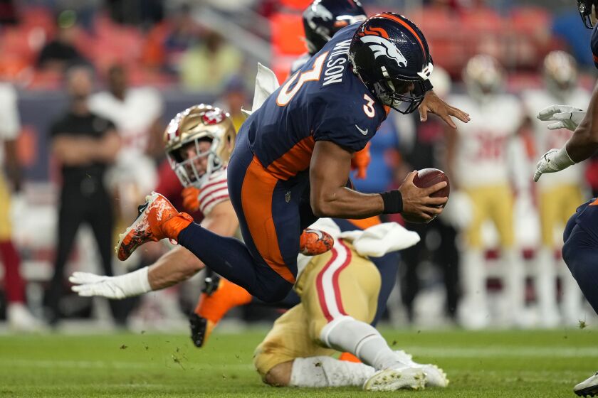 Denver Broncos quarterback Russell Wilson (3) is sacked by San Francisco 49ers defensive end Nick Bosa, rear, during the second half of an NFL football game in Denver, Sunday, Sept. 25, 2022. (AP Photo/Jack Dempsey)