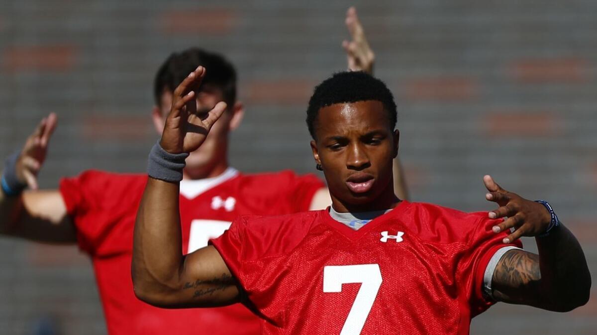 UCLA freshman quarterback Dorian Thompson-Robinson warms up during the first day of practice on Aug. 3.