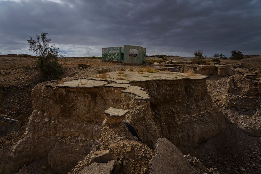 GHOR HADITHA, JORDAN -- APRIL 10, 2021: A ground has sunk with the appearance of multiple sinkholes at the former grounds of the Numeira Salt company in Ghor Haditha, Jordan, Saturday April 10, 2021. The Dead Sea is shrinking at a rate of anywhere from 3 to 5 feet a year, and in the last three decades, the Dead SeaOs level has fallen almost 100 feet. The rate of loss is accelerating, as are the sinkholes; they now number in the thousands, like a rash spreading on the exposed seabed. (Marcus Yam / Los Angeles Times)