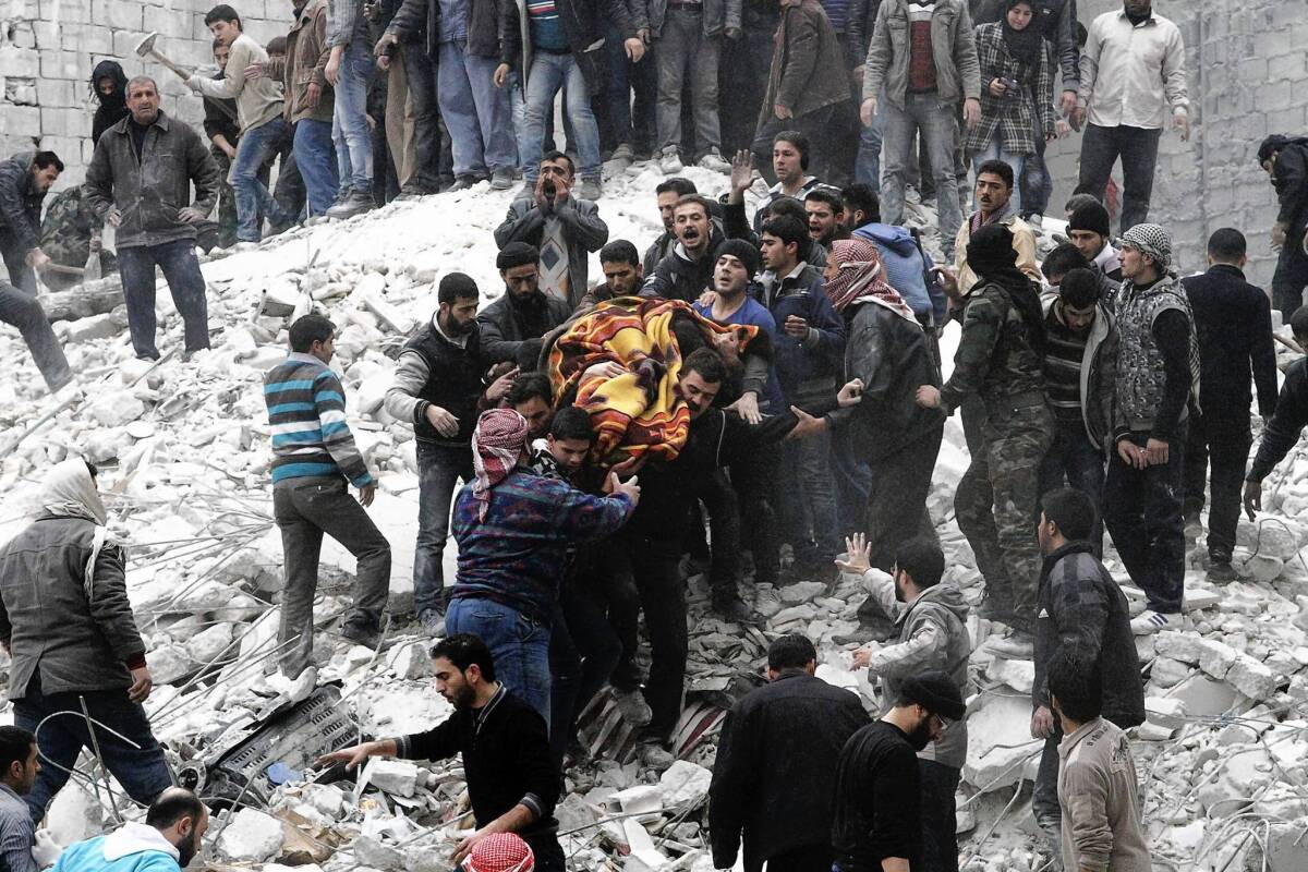 Syrians carry a body in Aleppo's Ansari neighborhood after a reported government airstrike. The opposition said the attack killed at least nine people.